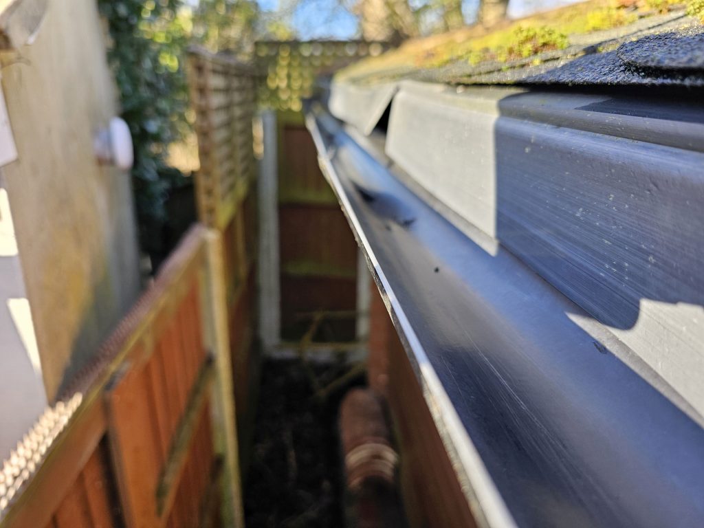 Gutter cleaning service removing leaves and debris